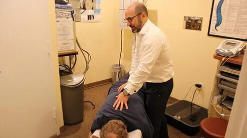 Dr. Jared Hoffman giving a patient an adjustment